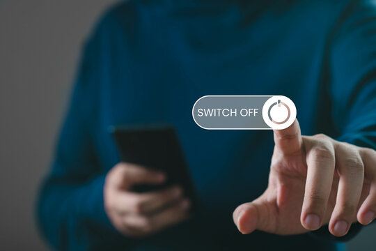 A person turning off a device with a 'Switch Off' button, showcasing modern technology interaction and digital lifestyle.
