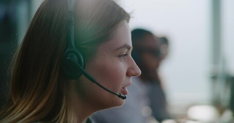 Call center office: Close up of young Caucasian technical customer support specialist in headset having conversation on call, solving problem, providing online help. Female hotline operator working.