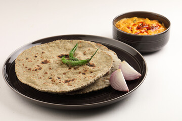 Indian traditional multigrain roti or millet flat bread.Made with chana ,caun, green moong , udad ,ragi , Jowar farmer's lunch Indian bread with chickpea powder curry