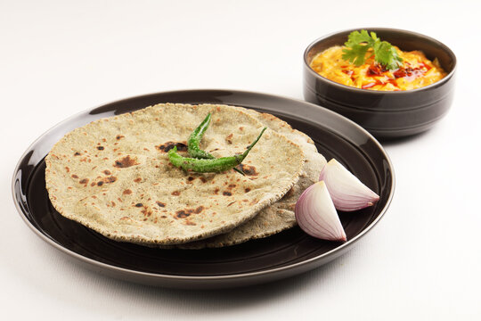 Indian traditional multigrain roti or millet flat bread.Made with chana ,caun, green moong , udad ,ragi , Jowar farmer's lunch Indian bread with chickpea powder curry