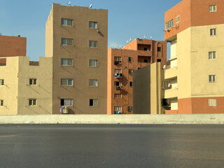 Colourful plastic brick like buildings in desert browns, Cairo, Egypt
