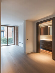 Modern interior of an apartment with large windows and warm lighting during the afternoon