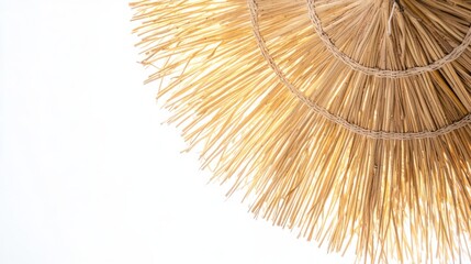 Classic straw beach umbrella with woven texture on clean white background