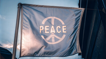 Peace flag with text, clear message, against a blue sky