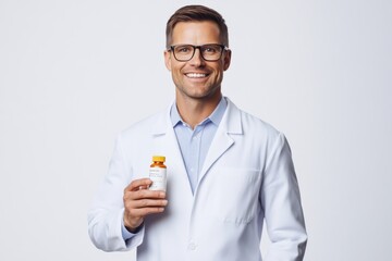 Male Doctor Holding Medicine in White Coat