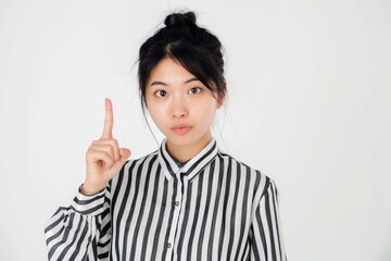 Young Asian woman with great idea poses in studio.