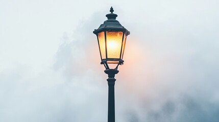 A Single Lit Street Lamp Against a Cloudy Sky