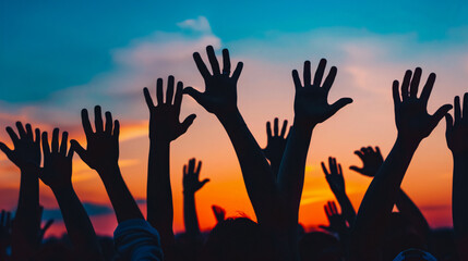 Silhouette of people raising their hands in celebration.