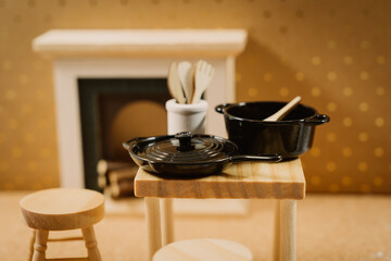 Warm kitchen scene with black pots and wooden utensils