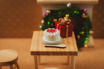 Christmas cake and gift with wreath in a cozy table scene