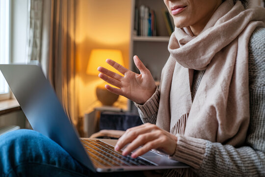 Businesswoman on a business trip making a video call from her laptop