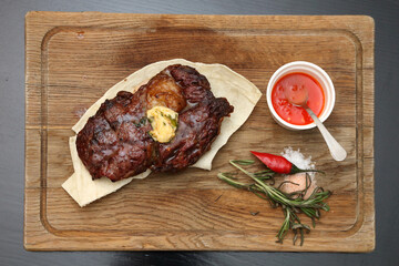 Medium rare steak placed on pita bread on a special wooden board. Beef steak on a wooden board.