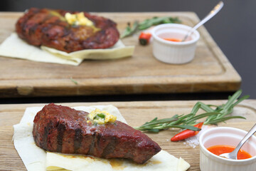 Medium rare steak placed on pita bread on a special wooden board. Beef steak on a wooden board.