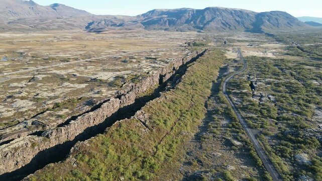 Icelandic Plate Fault. A large canyon with a mountain in the background