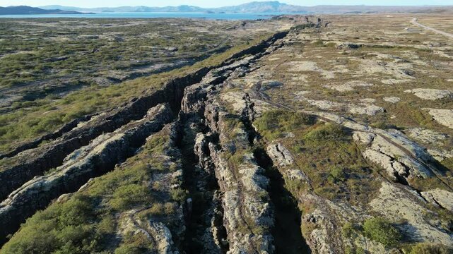 Icelandic Plate Fault. A large canyon with a mountain in the background
