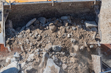 The excavator is pouring over the ground