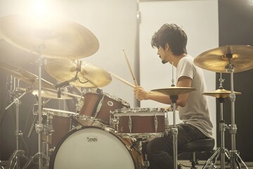 Fototapeta premium Intense drummer playing on stage with passion