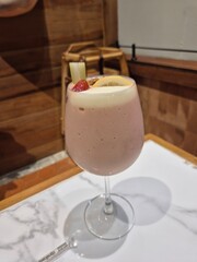 Tropical mixed fruit smoothie serving in the glass. Famous healthy and luxury beverage menu in Asian restaurant.