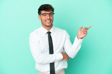 Business caucasian man isolated on blue background pointing finger to the side