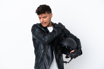 Young caucasian man with a motorcycle helmet isolated on white background suffering from pain in shoulder for having made an effort