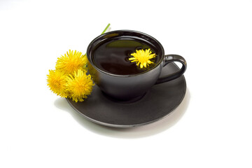 Dandelion infusion in black cup on white background