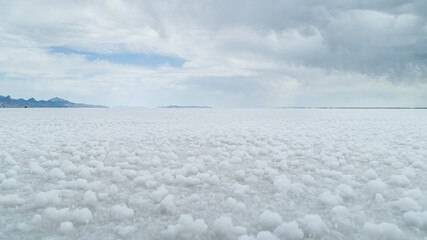 Vast White Salt Flats Under Overcast Sky with Horizon