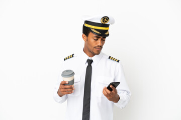African American Airplane pilot over isolated white background holding coffee to take away and a...