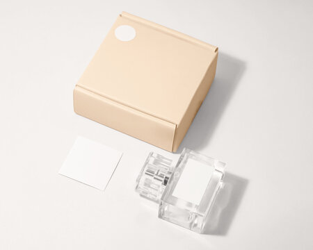 Perfume bottle mockup with plain white label and plain packaging box with minimalist studio scene background - Powered by Adobe