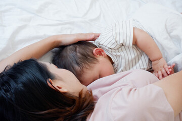 Baby sleeping and drinking breast milk.