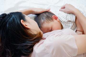 Baby sleeping and drinking breast milk.