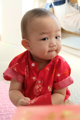 Fototapeta premium portrait of child in red suit