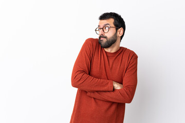 Caucasian handsome man with beard over isolated white background making doubts gesture while lifting the shoulders