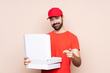 Man holding a pizza over isolated background