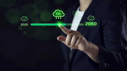 Businessman holding loading bar update of carbon reduction for green economy to reduce carbon...