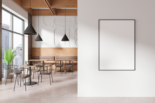 Blank framed poster on a wall in modern cafe interior. 3D Rendering