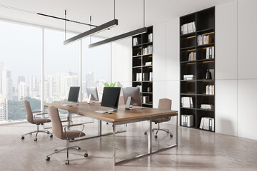 White coworking interior with tables and pc monitors, panoramic window