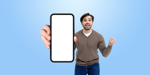 Crazy man with fist showing mockup blank smartphone in hand