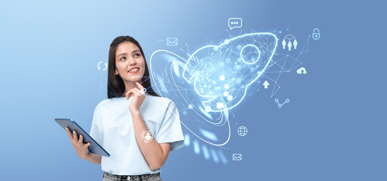 Smiling woman with tablet, glowing hologram of rocket with business icons