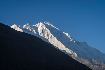 Early morning landscape view of snow-capped Rakaposhi peak in Karakoram mountain range seen from Karimabad, Gilgit-Baltistan, Pakistan