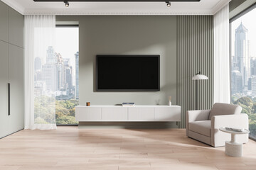 Cozy home living room interior with armchair and tv display, panoramic window