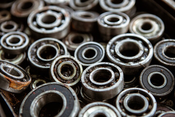 Many radial ball bearings of different sizes in a box - elements of machines and mechanisms