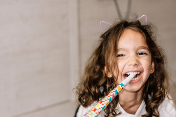 Close-up of smiling girl at a birthday party. Emotion concept.