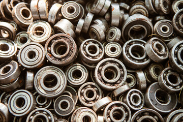 Many radial ball bearings of different sizes in a box - elements of machines and mechanisms