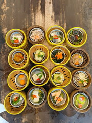 A variety of dim sum. Traditional Dimsum food served in a bamboo basket. Bamboo tray for steamed food.Cantonese term meaning small meals or snacks typically dimsum is eaten for breakfast or brunch.
