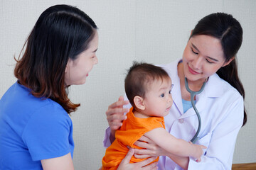 Female doctor examining a sick young child, Pediatrician concept, Pediatrician, Pediatrics.