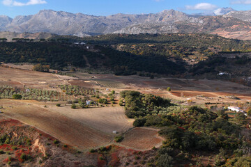 Landscape photo with a panoramic view of the valley and mountains in the background against a blue sky with clouds in the city of Ronda, Andalusia region, Spain	