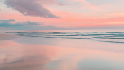 Obraz premium Serene Coastal Sunrise: A breathtaking panorama of a tranquil beach bathed in the soft, ethereal glow of a pastel sunrise. The gentle waves lap at the shore, reflecting the sky's vibrant hues. 