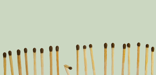 A broken matchstick among new matchsticks.