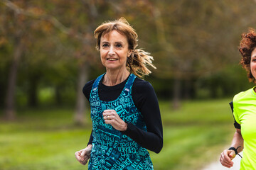 Senior women running together in a park, enjoying a healthy lifestyle