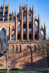 A beautiful red brick Gothic building. Ancient architecture.